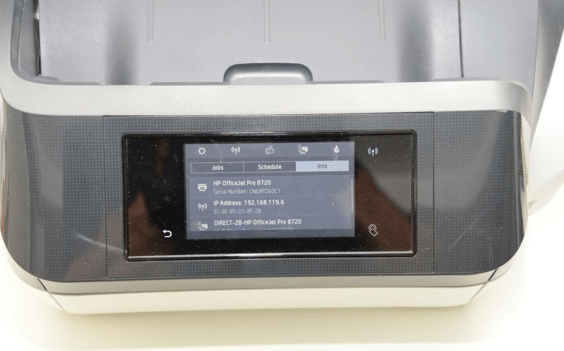 A printer’s control-panel screen showing its status and network details